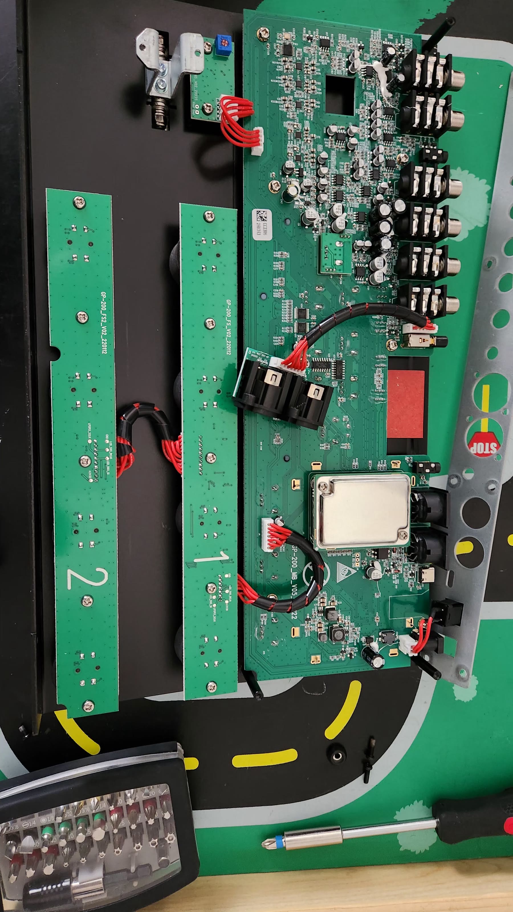 Opened Valeton GP-200 chassis showing the main circuit board, footswitch daughterboard, and ribbon cables
