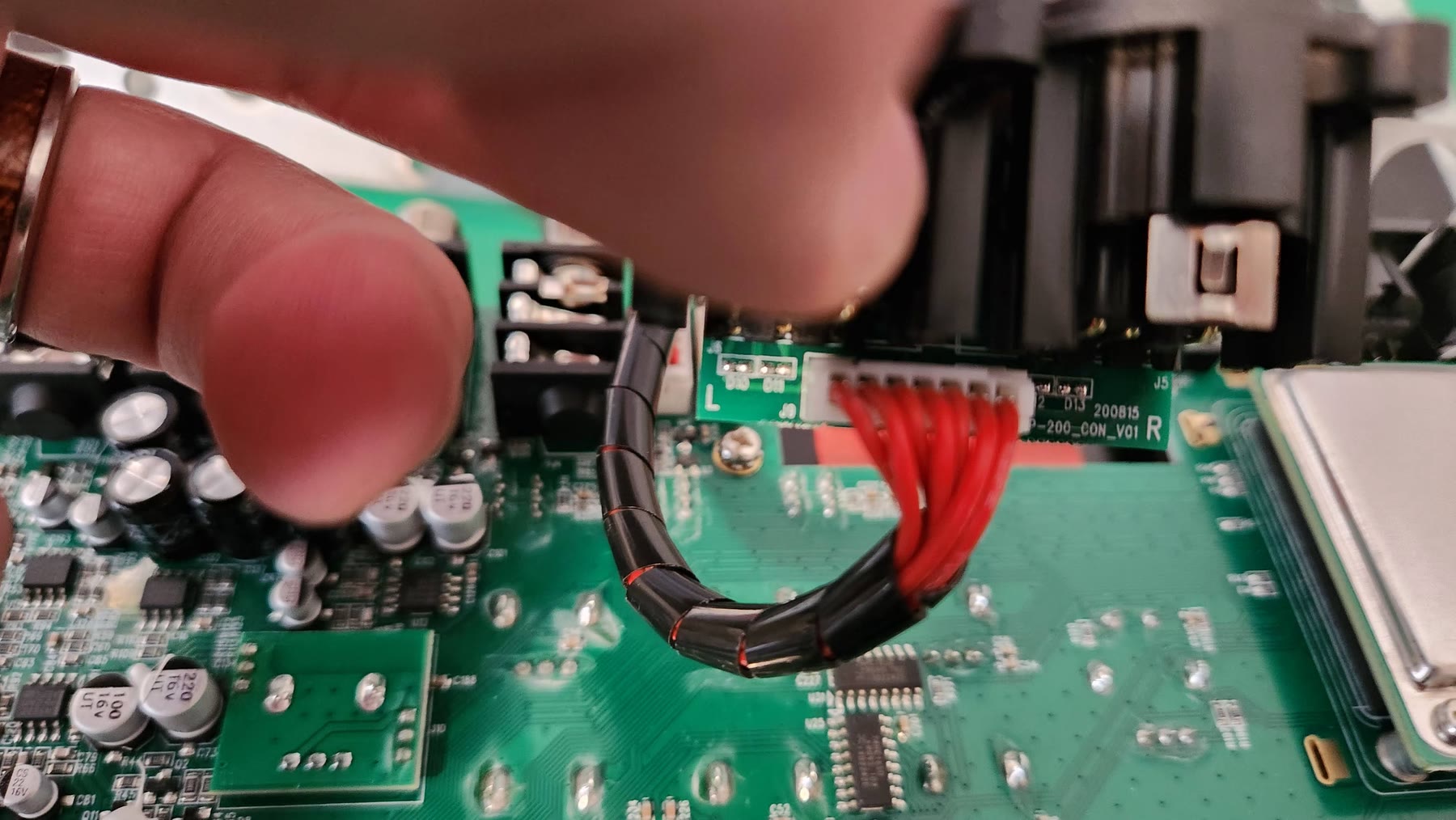 Top-down view of the XLR output daughterboard with its ribbon connector and chassis lugs
