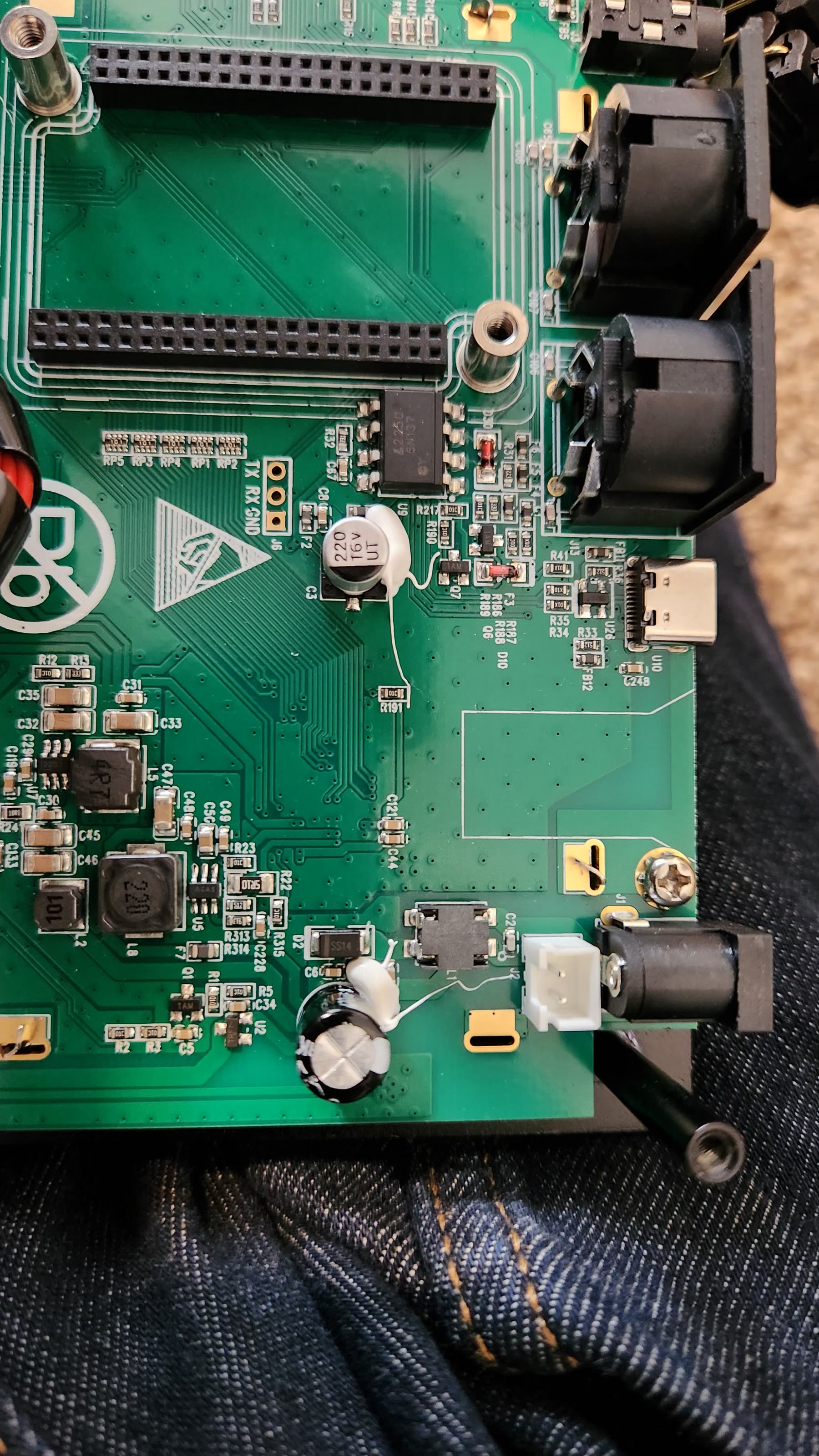 Mainboard cutouts and ground-plane traces around the rear audio jack sockets