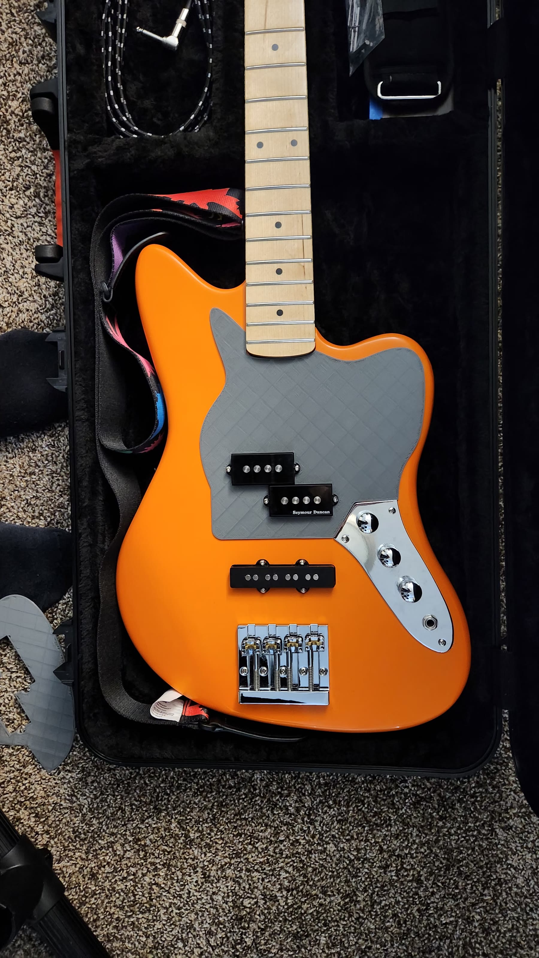 Full-size grey 3D-printed pickguard prototype mounted on the bass body