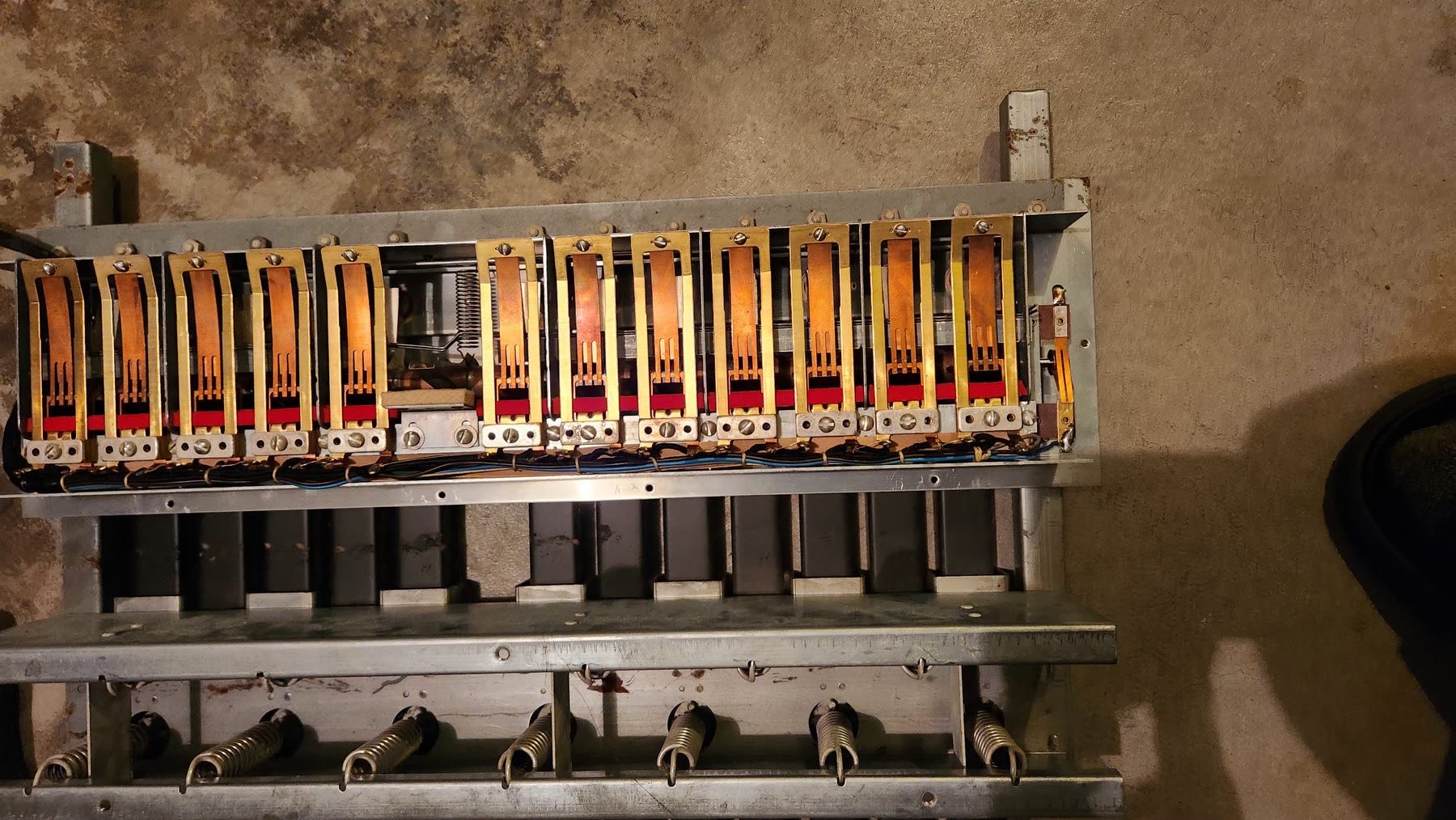 Interior frame, wiring, and return springs of the wooden organ pedal board